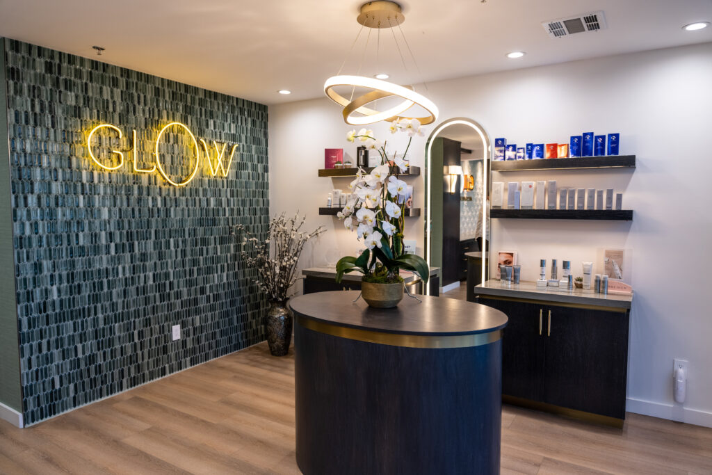 Modern spa interior featuring a stylish reception area with a neon 